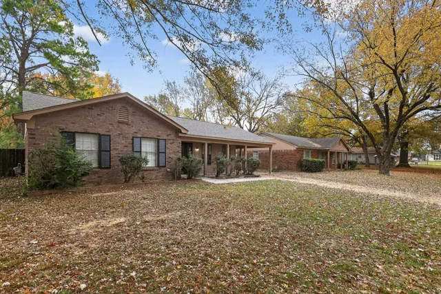 a front view of house with yard and trees