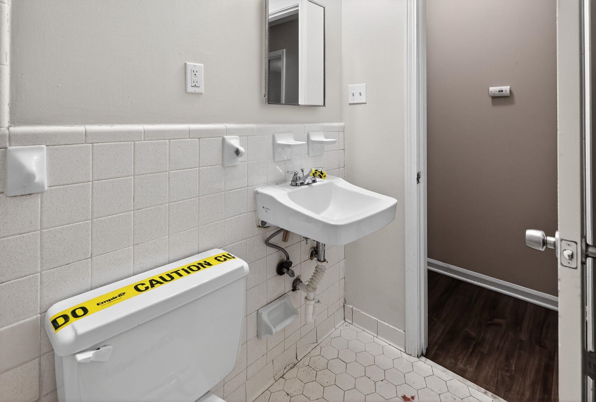 3860 Castleman Street Memphis, TN 38118 - Photo 27 of 30 a bathroom with a sink a toilet and a mirror