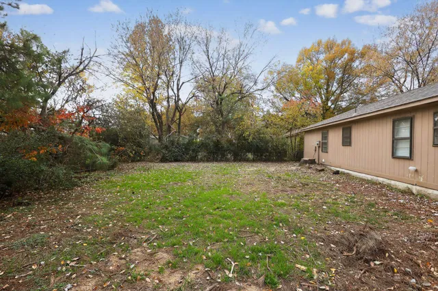 a view of a backyard with large trees