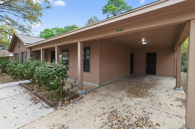 a view of a front door and a yard