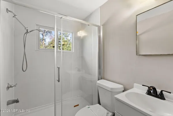 a bathroom with a sink toilet and mirror