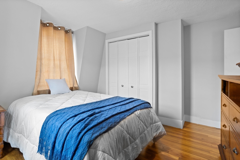 89 Prospect Street Somerville, MA 02143 - Photo 13 of 21 a bedroom with a bed and a window