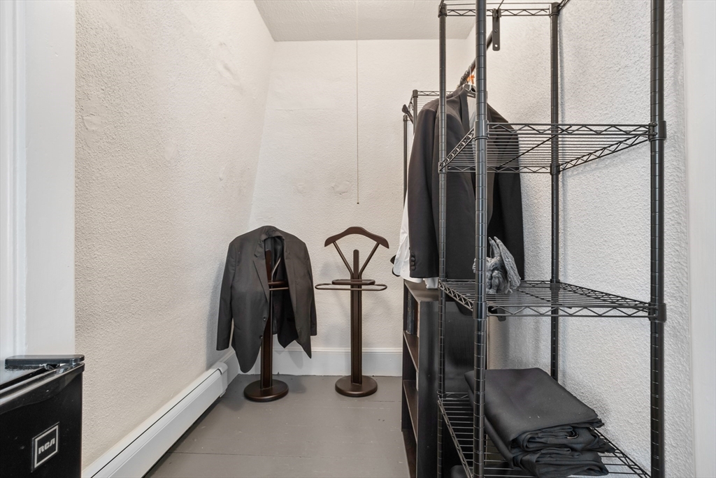 89 Prospect Street Somerville, MA 02143 - Photo 15 of 21 a view of walk in closet with clothes