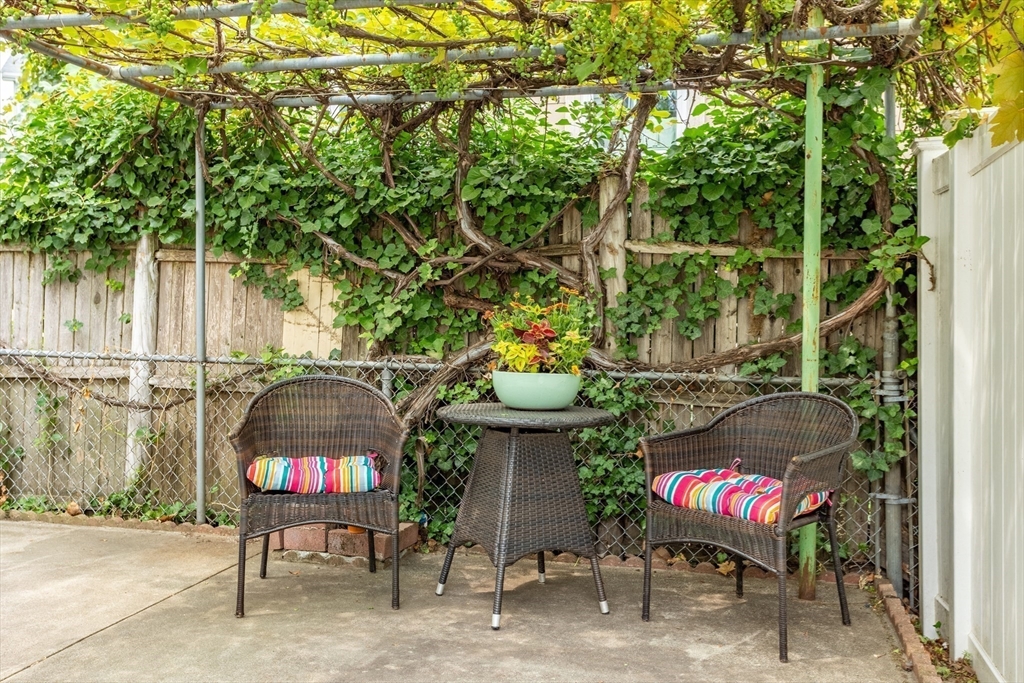 89 Prospect Street Somerville, MA 02143 - Photo 17 of 21 a view of a chairs and table in backyard