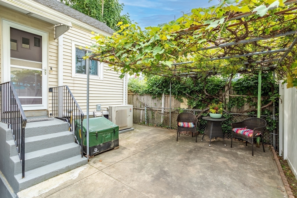 89 Prospect Street Somerville, MA 02143 - Photo 18 of 21 a view of a chairs and table in the back yard of the house