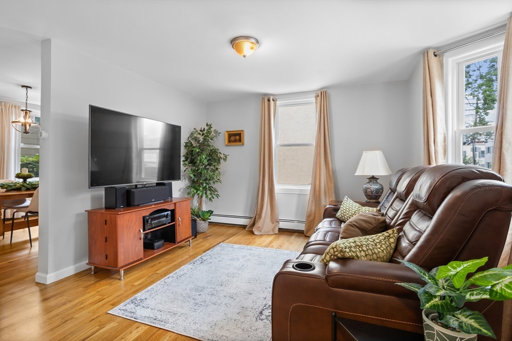 89 Prospect Street Somerville, MA 02143 - Photo 3 of 21 a living room with furniture and a flat screen tv