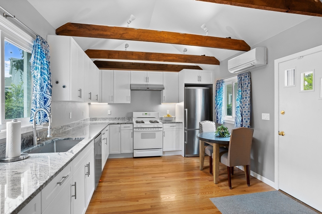89 Prospect Street Somerville, MA 02143 - Photo 7 of 21 a kitchen with granite countertop cabinets stainless steel appliances and a dining table