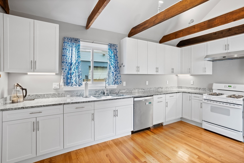 89 Prospect Street Somerville, MA 02143 - Photo 8 of 21 a kitchen with granite countertop white cabinets and white appliances