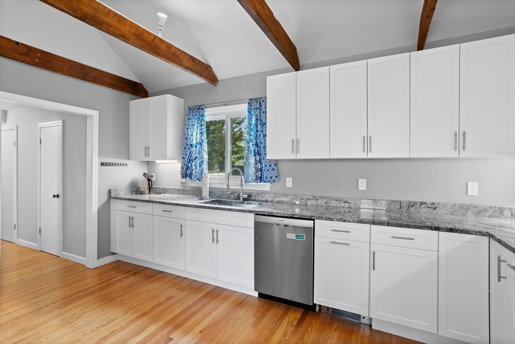 89 Prospect Street Somerville, MA 02143 - Photo 10 of 21 a kitchen with granite countertop cabinets stainless steel appliances a sink and a window