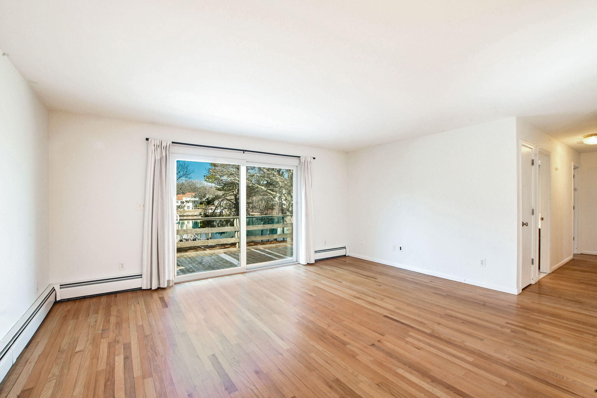 5 Rivers View Road East Falmouth, MA 02536 - Photo 16 of 44 an empty room with wooden floor and windows