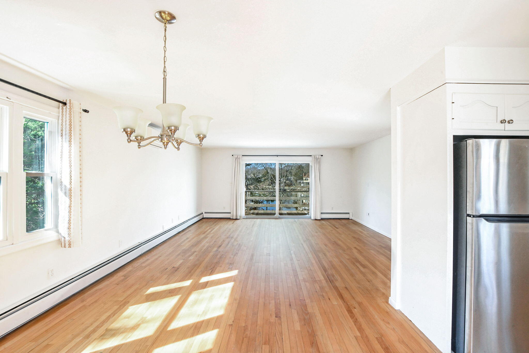 5 Rivers View Road East Falmouth, MA 02536 - Photo 18 of 44 a view of an empty room with a window and wooden floor