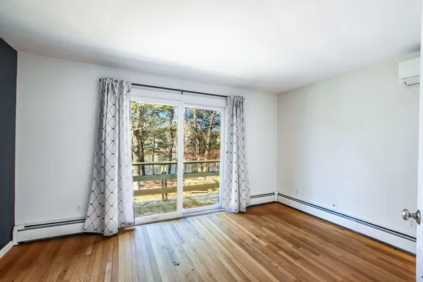 a bedroom with a large bed and a large window