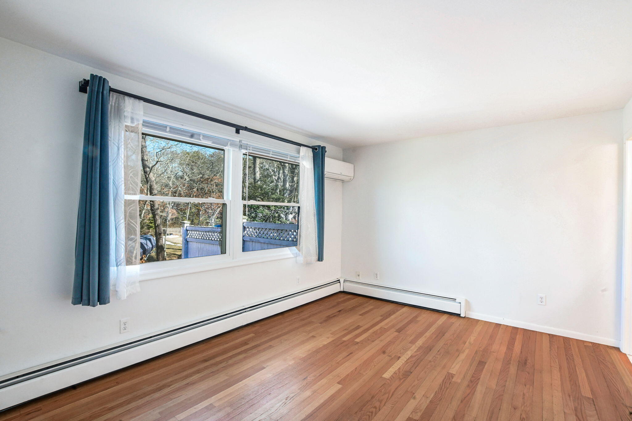 5 Rivers View Road East Falmouth, MA 02536 - Photo 30 of 44 an empty room with wooden floor and windows