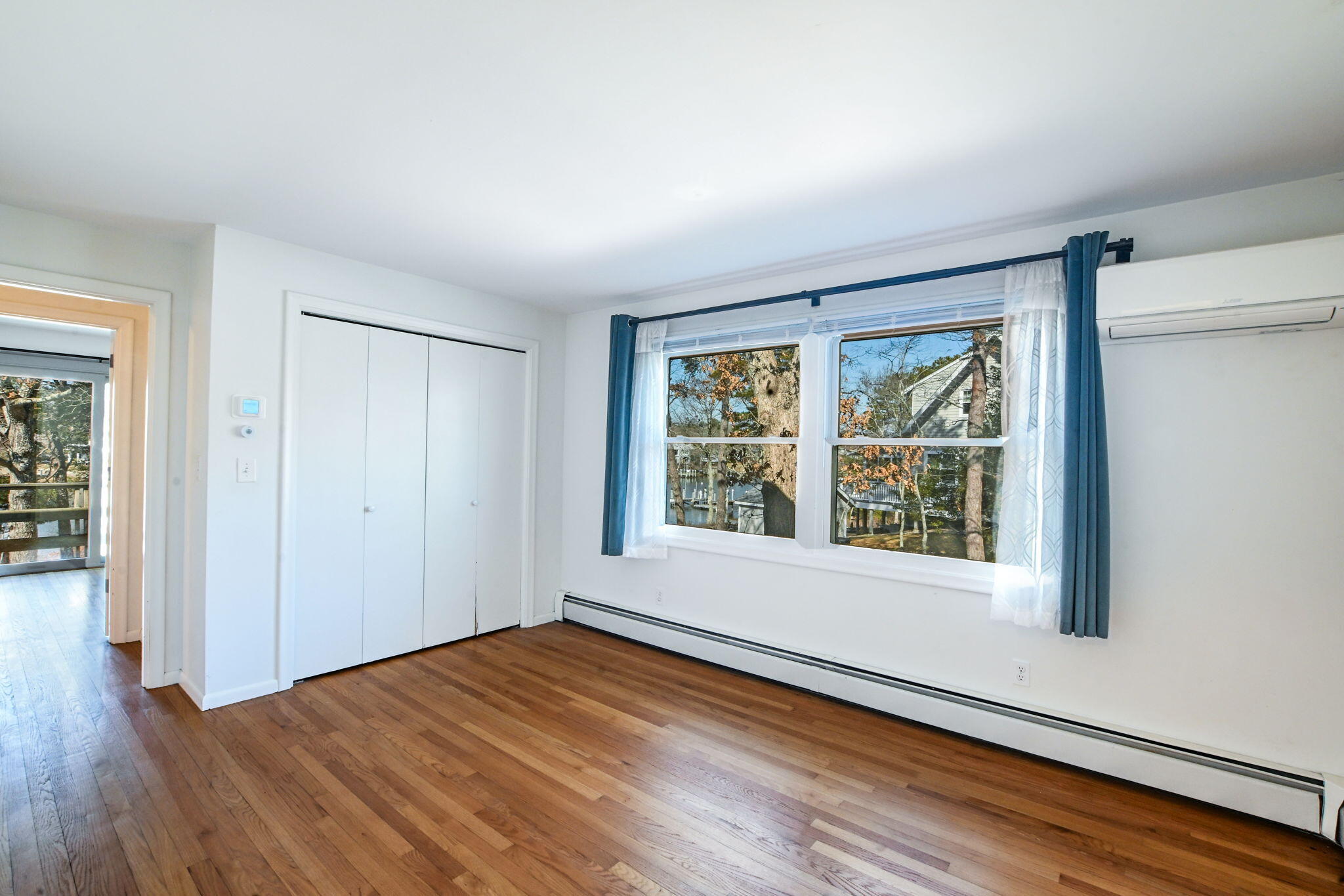 5 Rivers View Road East Falmouth, MA 02536 - Photo 31 of 44 an empty room with wooden floor and windows