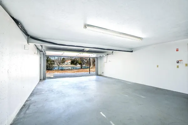 an empty room with large windows and painted walls