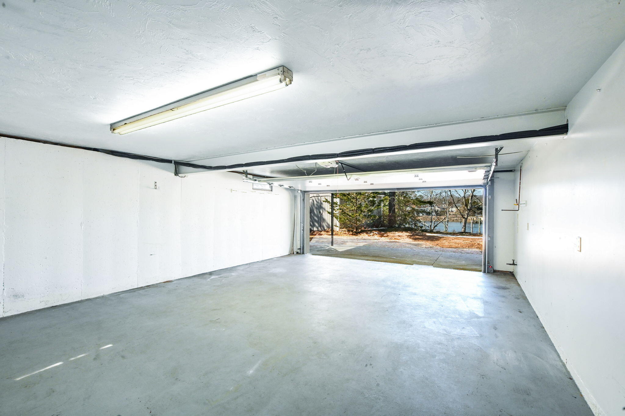 5 Rivers View Road East Falmouth, MA 02536 - Photo 33 of 44 an empty room with large windows and painted walls