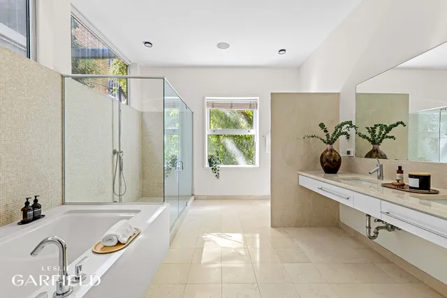 a bathroom with a tub sink and mirror