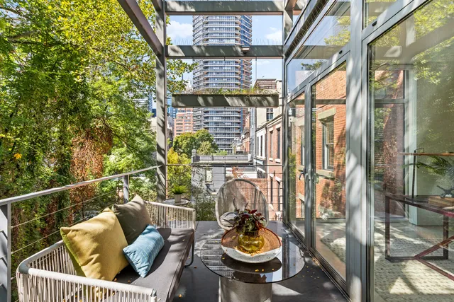 a view of a tables and chairs in back yard of a house