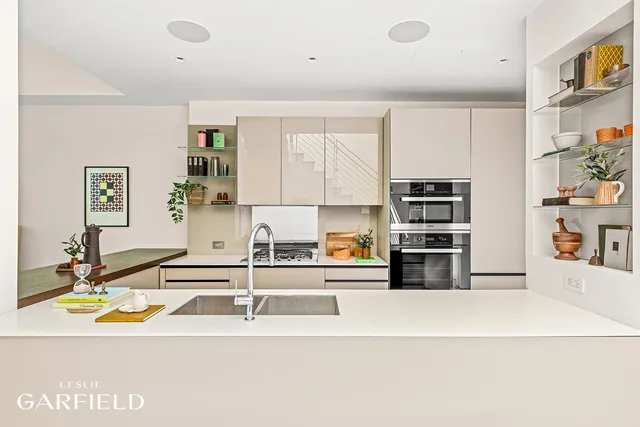 a kitchen with stainless steel appliances a sink and a stove top oven