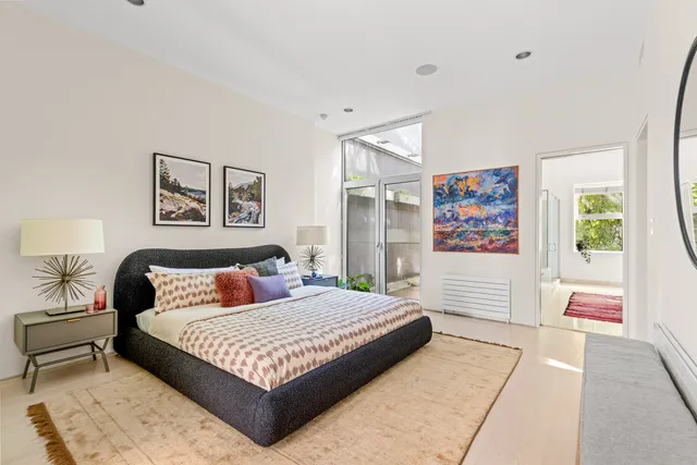 a bedroom with a large bed and a couch