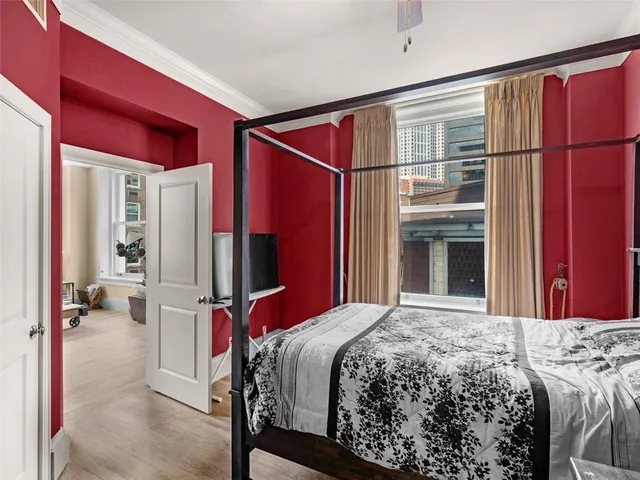 a bedroom with a bed and a chandelier