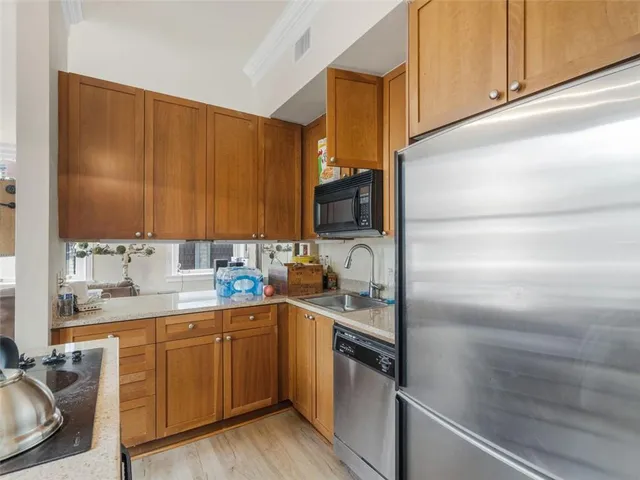 a kitchen with a sink cabinets and appliances