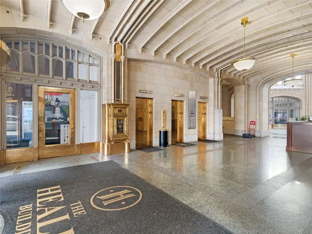 a view of lobby with furniture and a chandelier