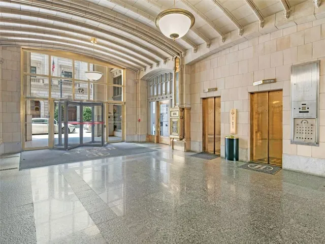 an empty room with entrance and windows