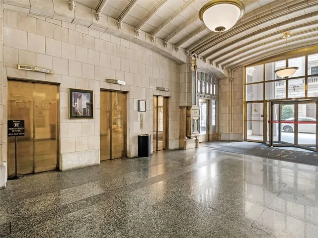 a view of a hallway with wooden floor and entryway