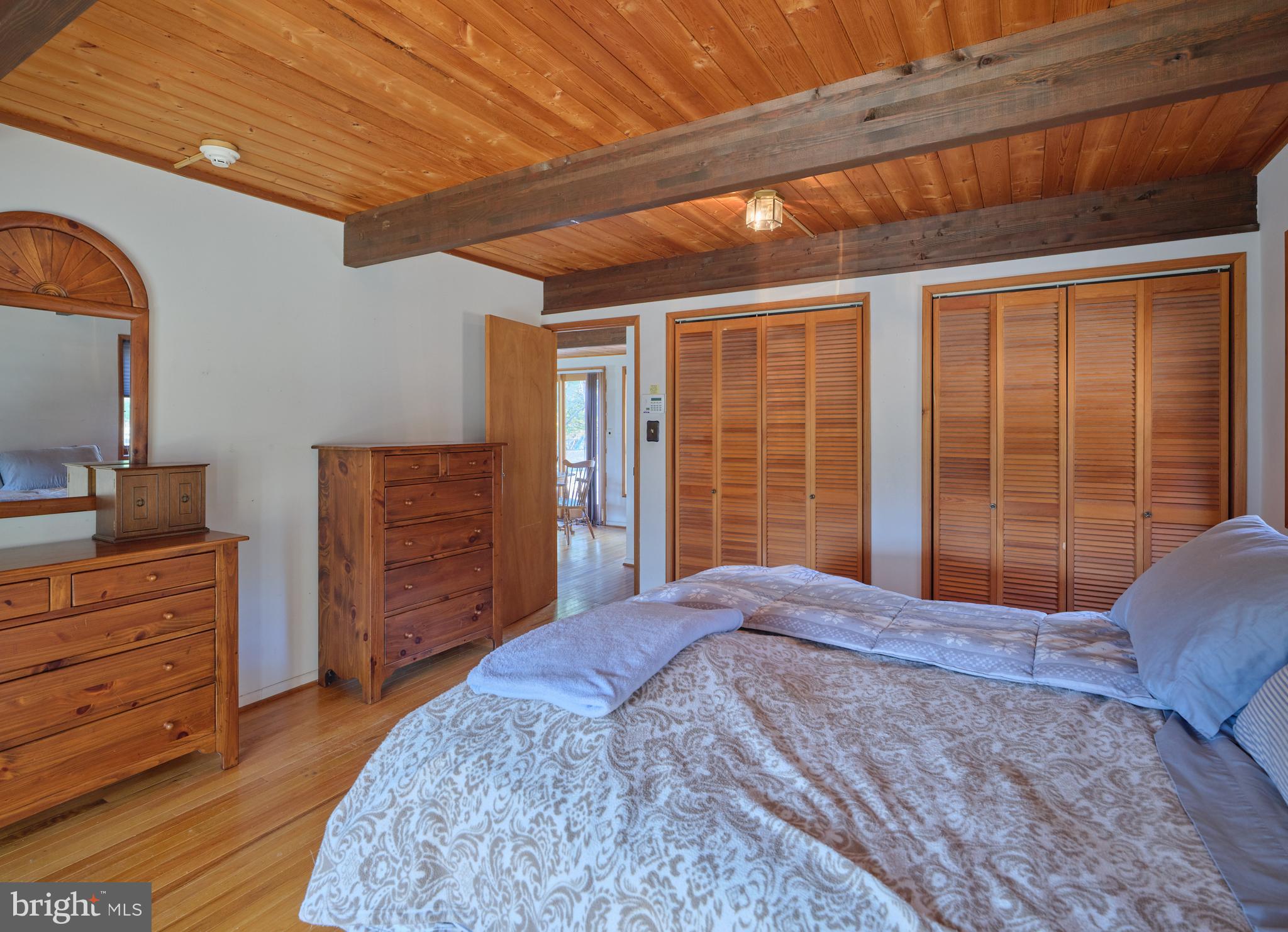 2999 Comfort Road New Hope, PA 18938 - Photo 15 of 40 a bedroom with a bed closet and flat tv screen