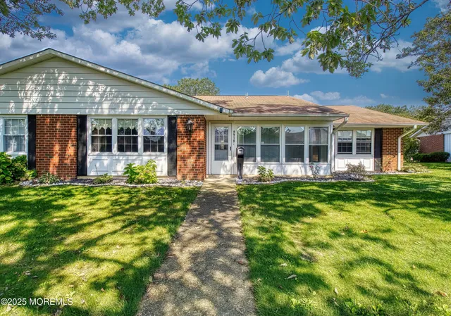 a view of a house with a yard and plants