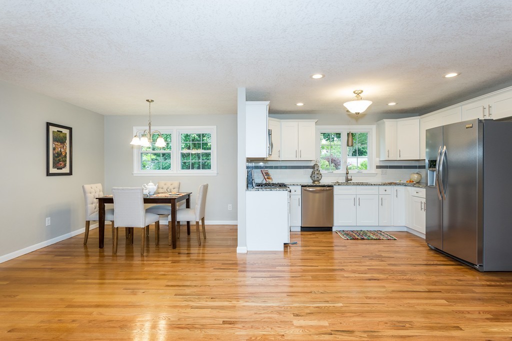 29 Mary Coburn Road Springfield, MA 01129 - Photo 5 of 30 a kitchen with stainless steel appliances granite countertop a dining table chairs refrigerator and cabinets