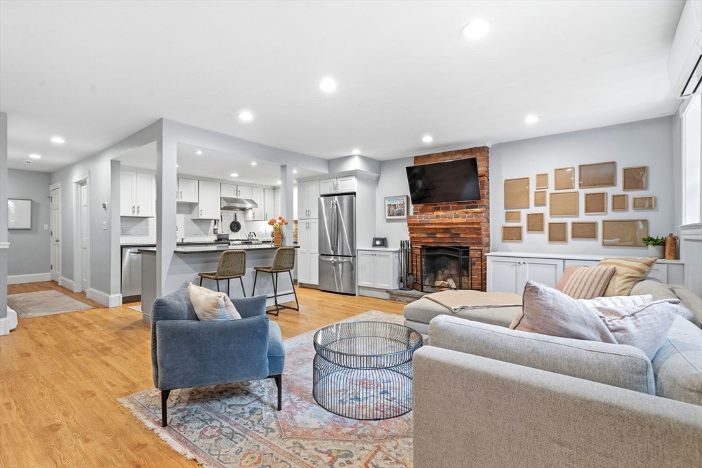 35 High Street, Unit 1 Boston, MA 02129 - Photo 27 of 33 a living room with furniture a fireplace and a flat screen tv