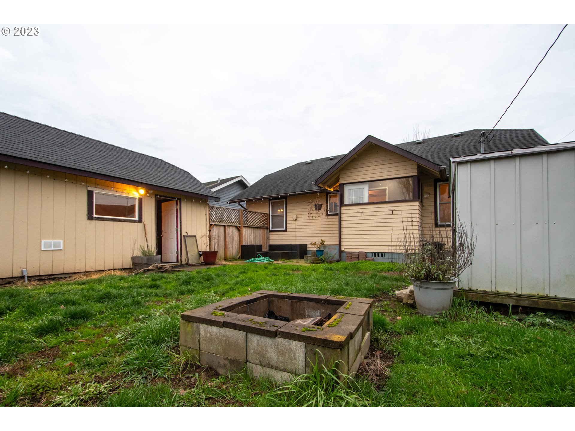 2818 Field Street Longview, WA 98632 - Photo 23 of 34 a backyard of a house with wooden fence table and chairs