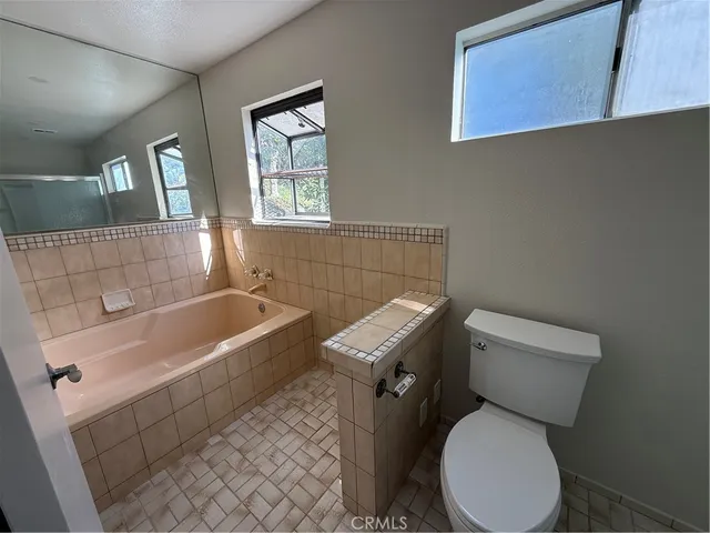 a bathroom with a toilet and a shower