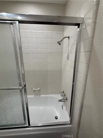 an empty room with closet and a chandelier fan