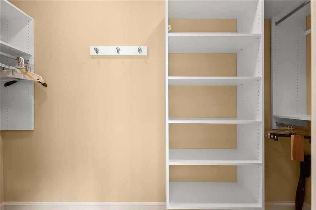 322 Edwards Brook Lane Canton, GA 30115 - Photo 57 of 99 a view of walk in closet with empty racks