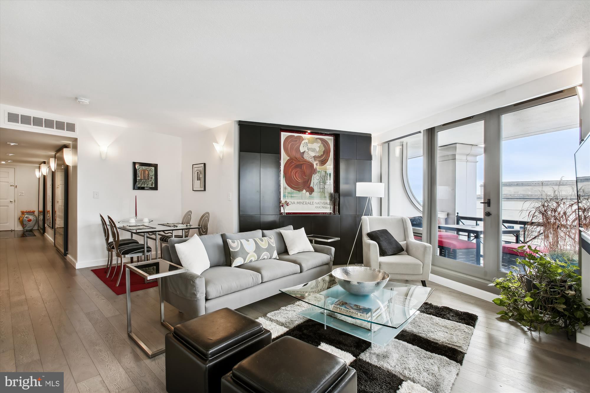 701 Pennsylvania Avenue Northwest, Unit 1221 Washington, DC 20004 - Photo 1 of 41 a living room with furniture and floor to ceiling windows