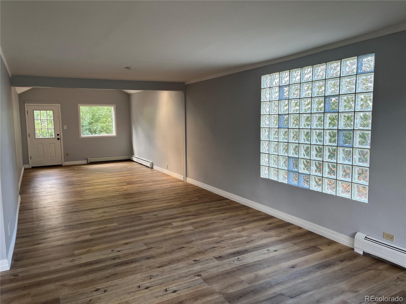 4315 Balsam Street, Unit A Wheat Ridge, CO 80033 - Photo 2 of 21 a view of an empty room with wooden floor and a window