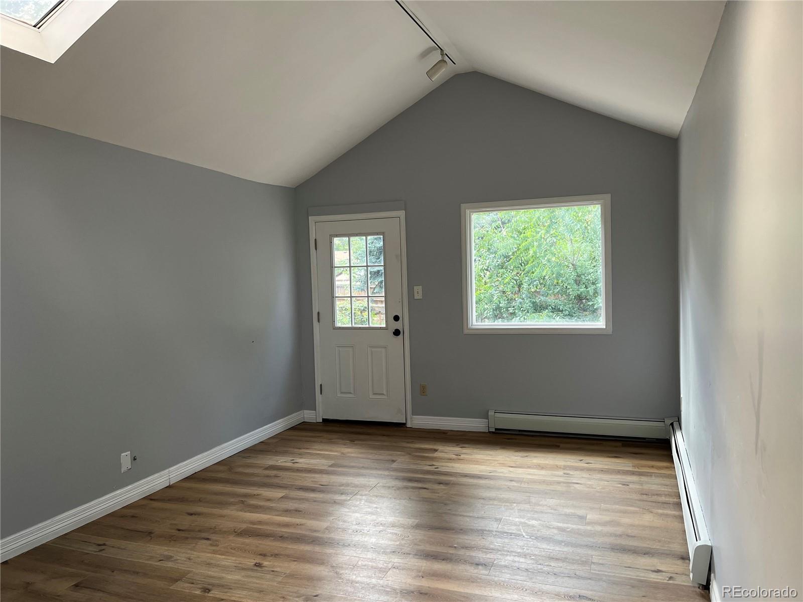 4315 Balsam Street, Unit A Wheat Ridge, CO 80033 - Photo 3 of 21 an empty room with wooden floor and windows