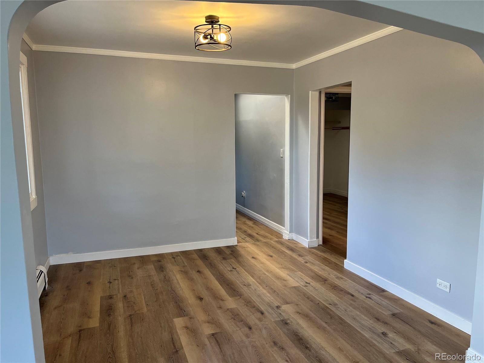 4315 Balsam Street, Unit A Wheat Ridge, CO 80033 - Photo 7 of 21 an empty room with wooden floor closet and windows