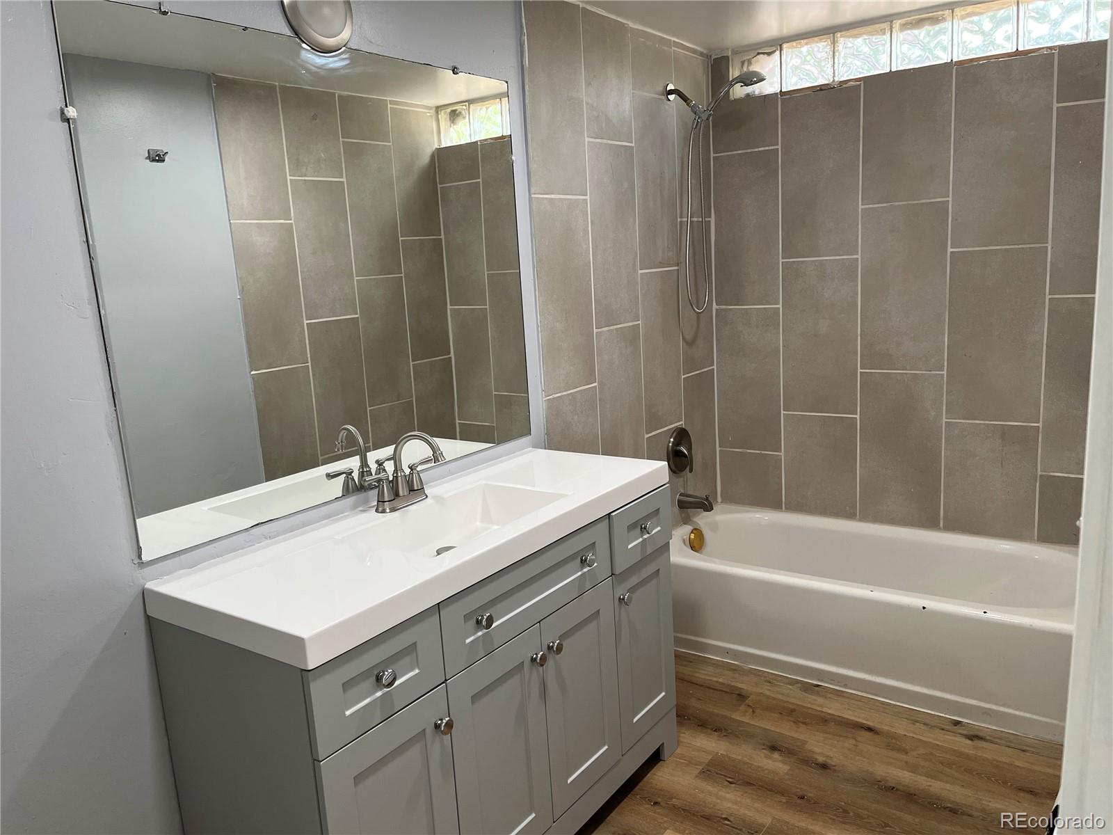 4315 Balsam Street, Unit A Wheat Ridge, CO 80033 - Photo 8 of 21 a bathroom with a sink mirror toilet and bathtub