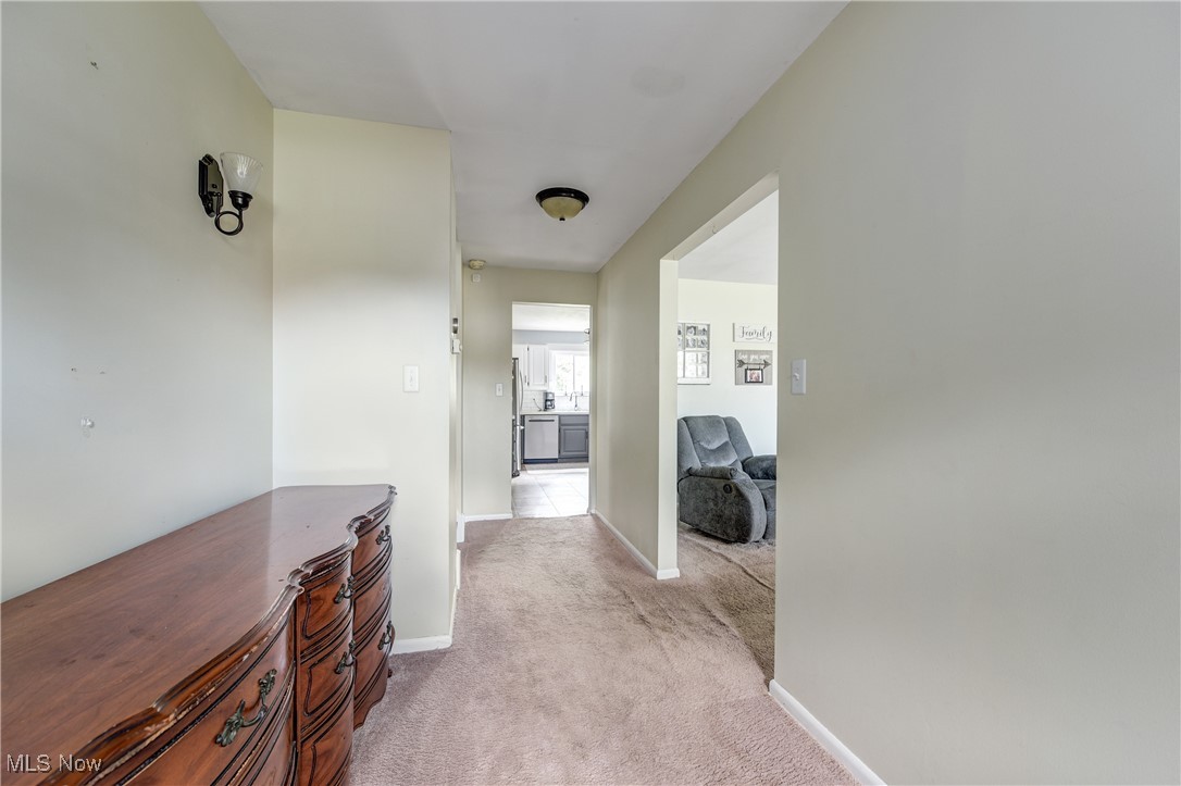 13765 Newton Road Cleveland, OH 44130 - Photo 3 of 42 Corridor with light colored carpet and baseboards