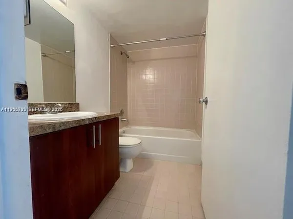 a bathroom with a sink a toilet a mirror and shower