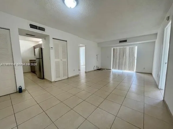 an empty room with a washing machine and mirrors