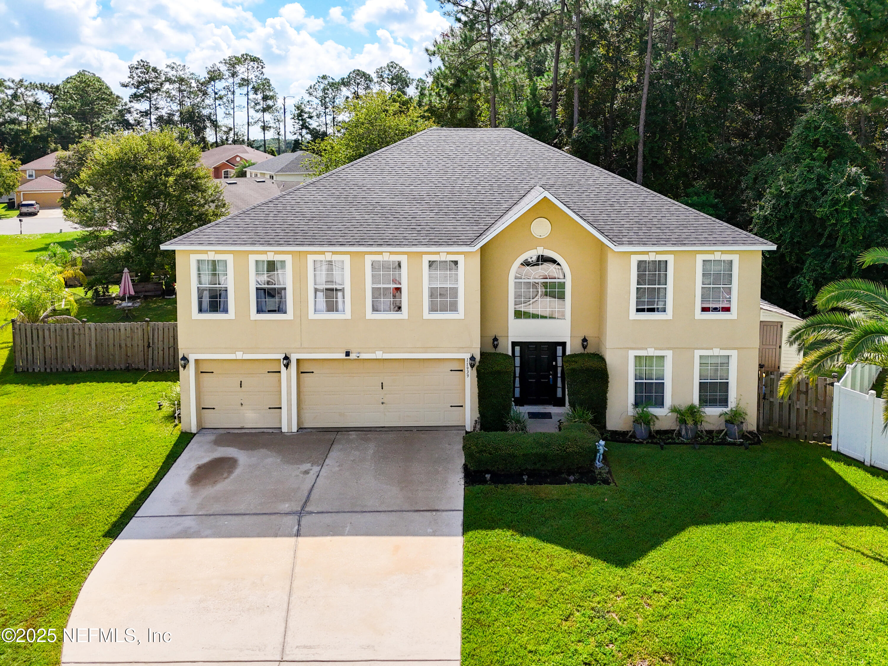 11939 Iron Creek Road Jacksonville, FL 32218 - Photo 2 of 73 a front view of a house with a yard and garage