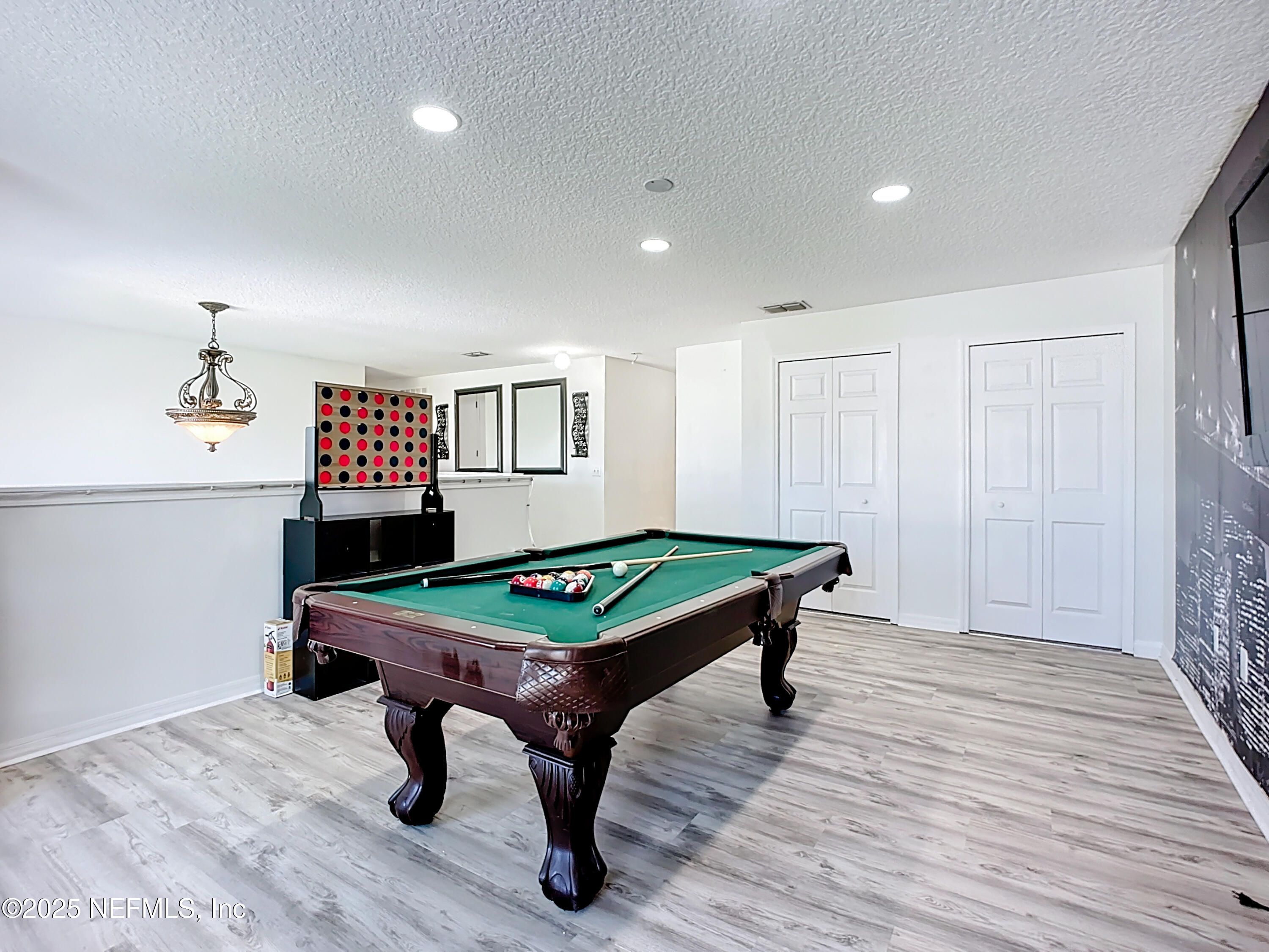 11939 Iron Creek Road Jacksonville, FL 32218 - Photo 31 of 73 a room with furniture pool table and wooden floor