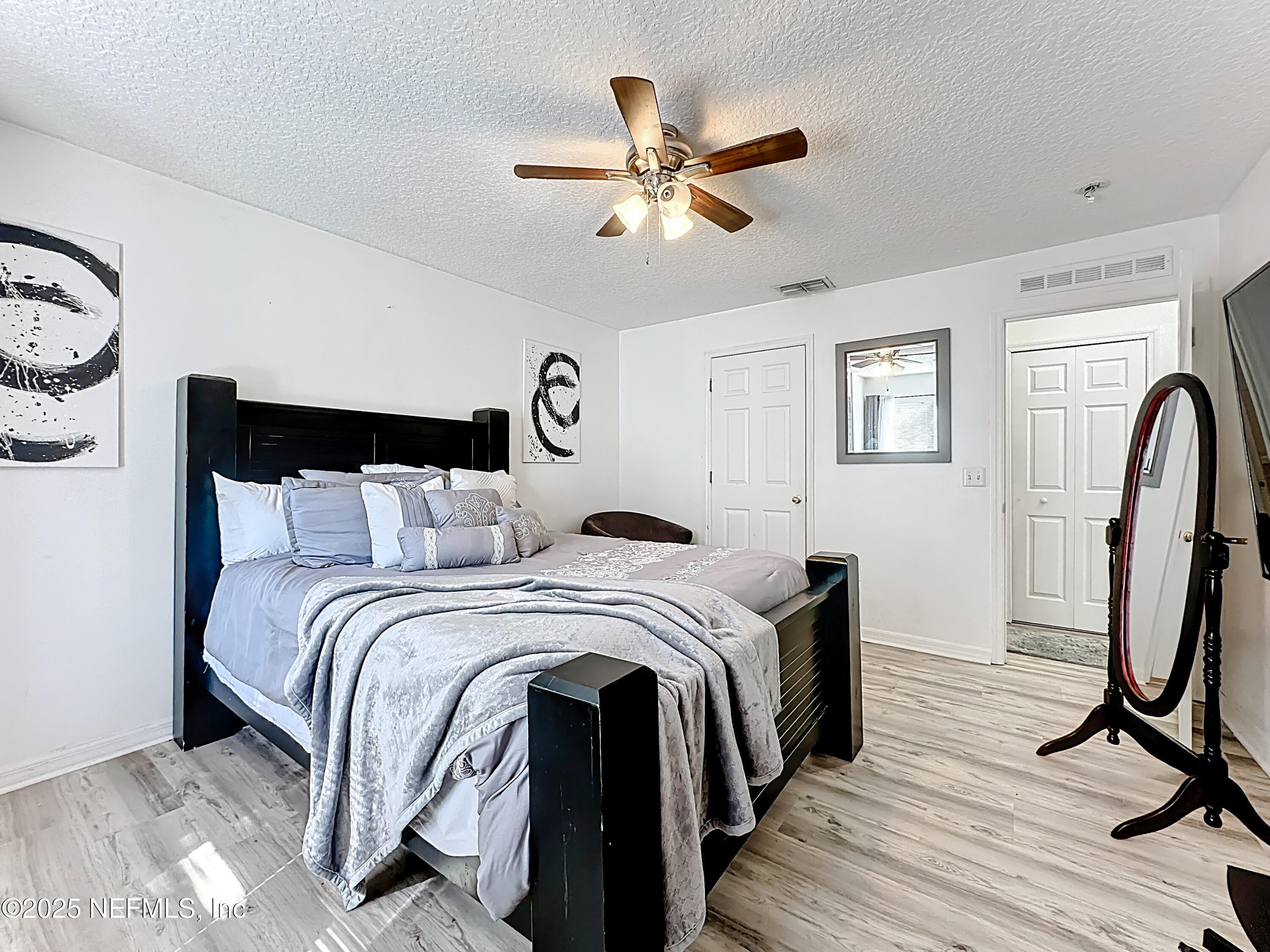 11939 Iron Creek Road Jacksonville, FL 32218 - Photo 43 of 73 a bed room with a bed and a chandelier