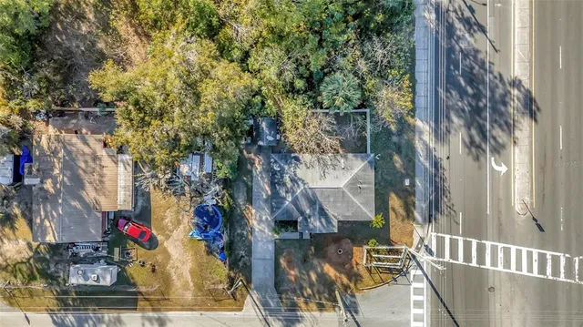 an aerial view of a house with a yard