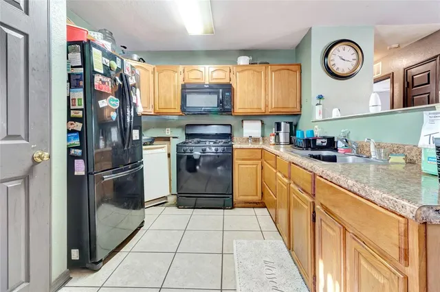 a kitchen with stainless steel appliances granite countertop a refrigerator and a stove